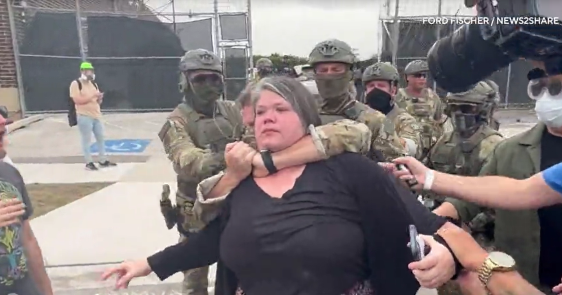 Federal agent grabs protester by the throat on Chicago sidewalk and body-slams him to the ground, weapon dangling from his back